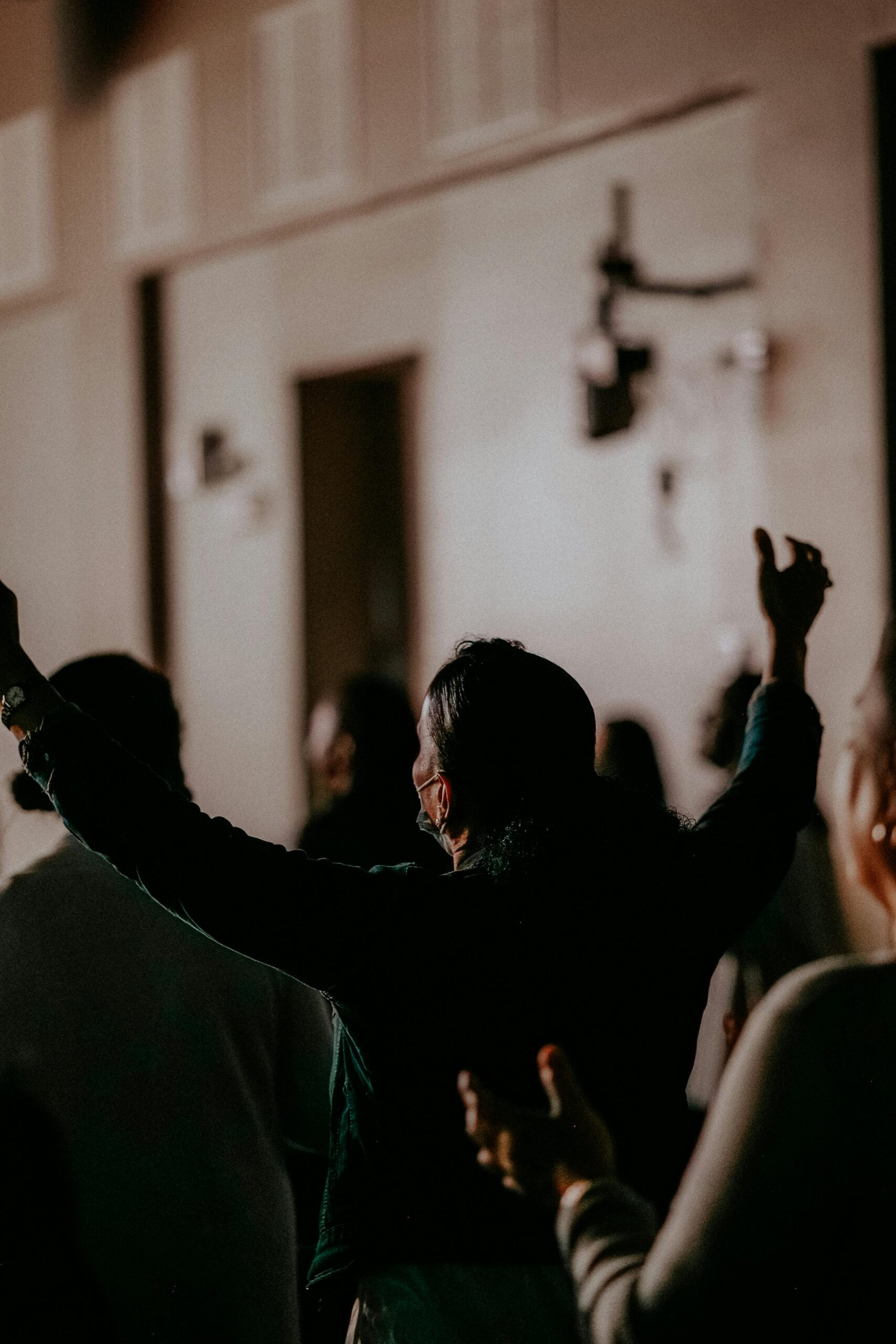A devotional gathering with people in prayer, expressing faith and unity.