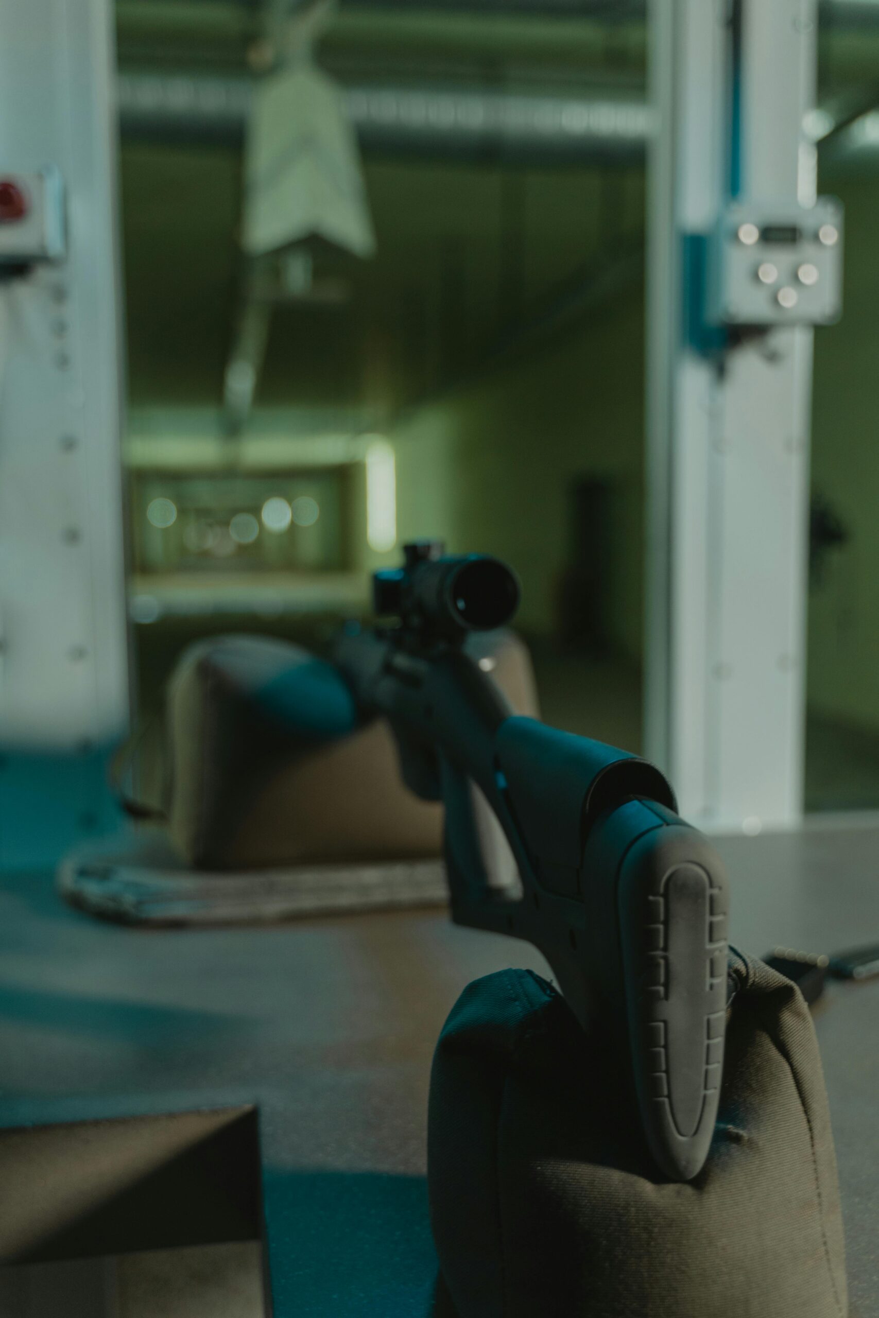 A sniper rifle setup for target practice in an indoor shooting range with a focus on accuracy.
